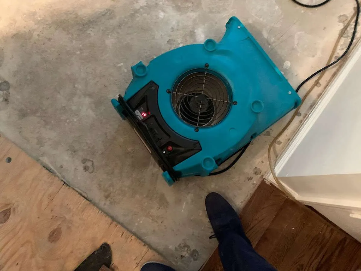 Air mover drying subfloor during Leak Detection & Repair in Geneva